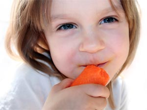 child eating carrot